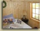 The Master bedroom in the Up Top log cabin