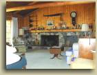 The living room and fireplace in the Tidey Lodge